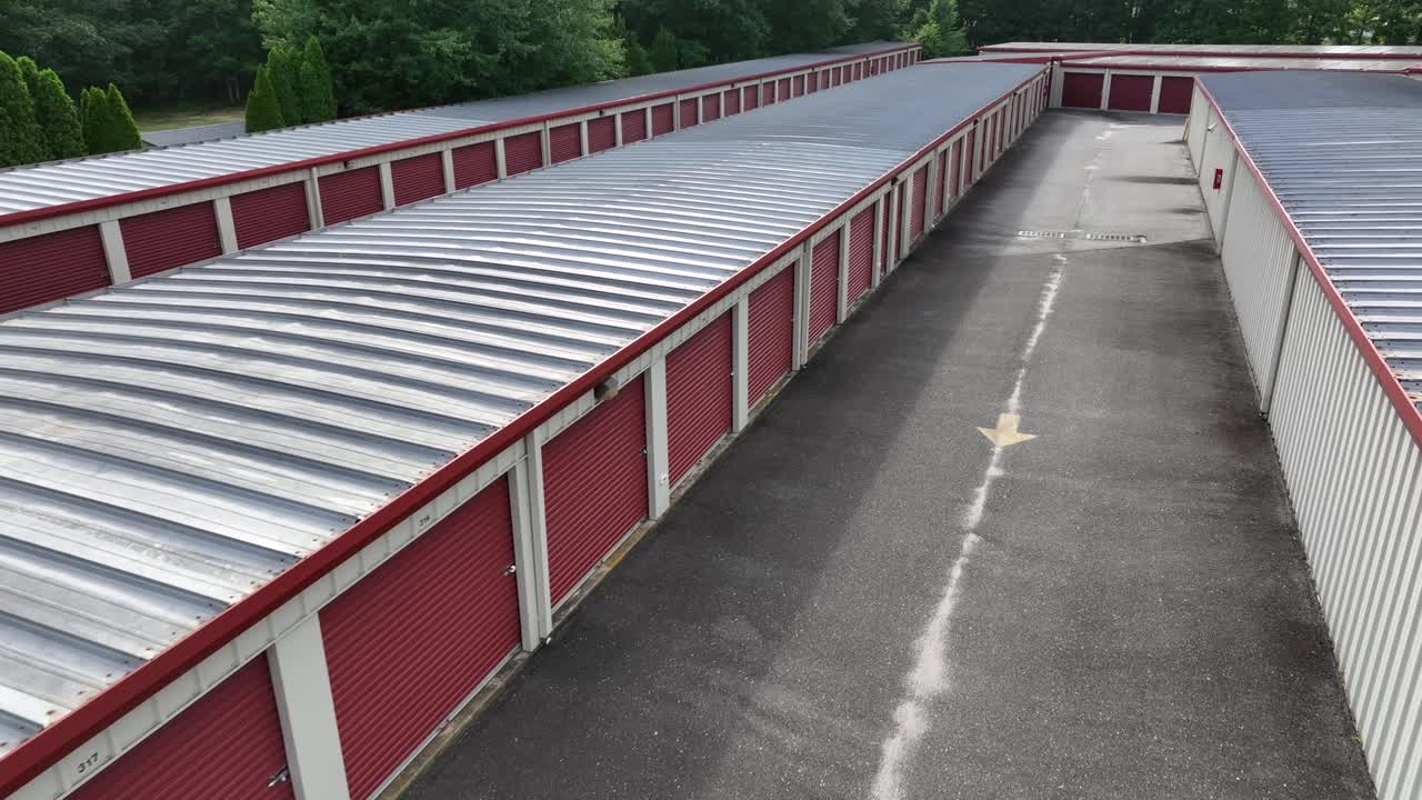 Red Self Storage Unit Buildings or Warehouse Temporary Storage at sunny day. American suburb garage. Aerial view. Summer season in New Jersey, USA