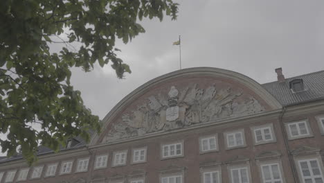 slotsholmsgade building in copenhagen on a cloudy day log