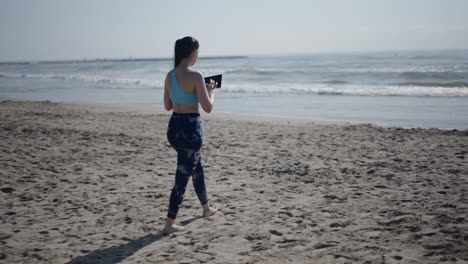 woman on the beach with tablet