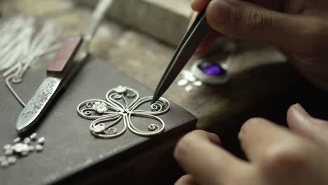 jeweler at work in jewelry. desktop for craft jewelry making with professional tools. close up view of tools. thailand.