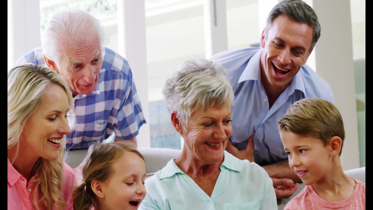 Multi-generation family sitting together in living room