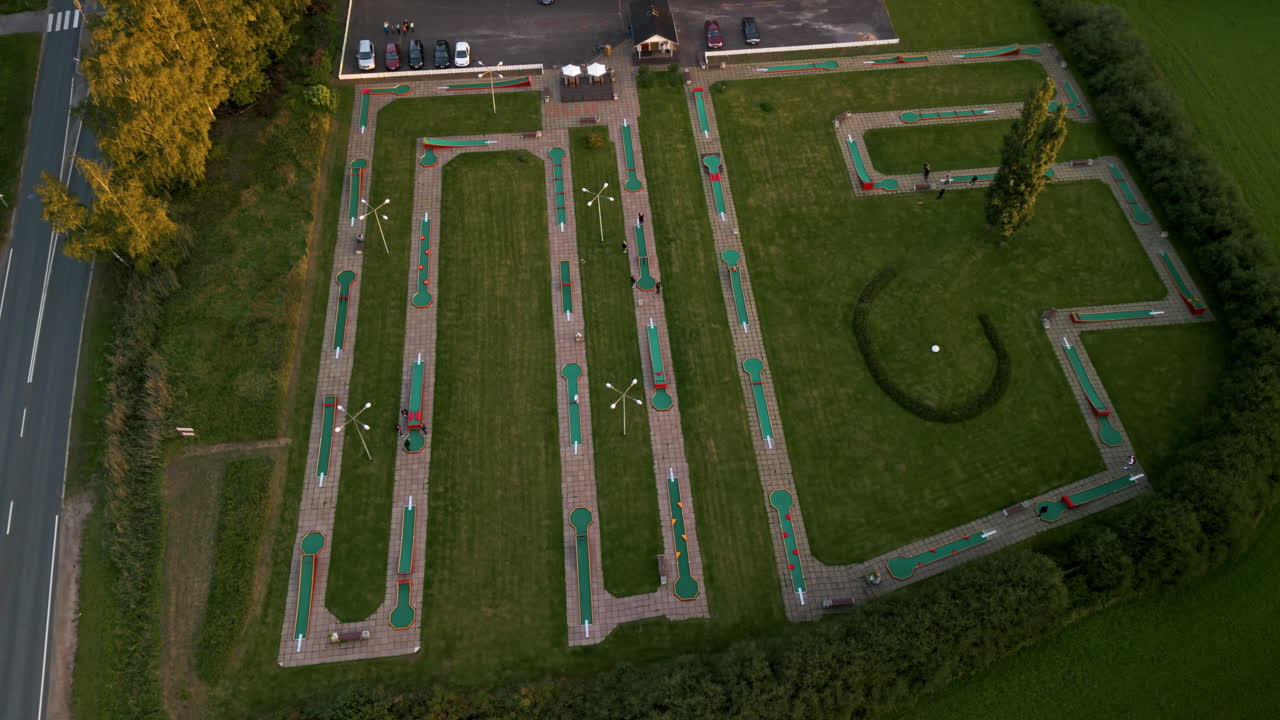 Wide shot of a small mini golf course in a green park