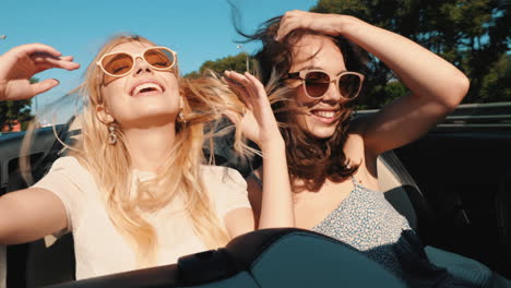 happy friends on a road trip in a convertible