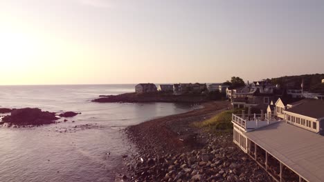 Aerial-sunset-of-Ogunquit-Maine-USA-Atlantic-Ocean-coastline-with-waterfront-beach-house-hotel-resort