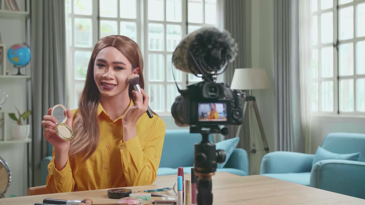 Influencer Young Transgender Woman Blogger Talks About Makeup. Transgender Woman Recording Video Blog Tells How To Be Beautiful. Blogger Talks Facial Beauty Treatments. Vlogger Broadcasts How To Use Of Cosmetic In Home Studio