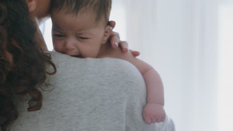 mother holding baby calming tired newborn gently soothing restless infant nurturing child loving mom enjoying motherhood at home