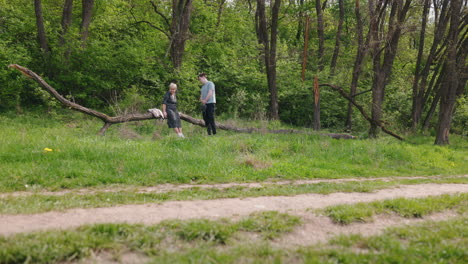 couple and dog in a forest