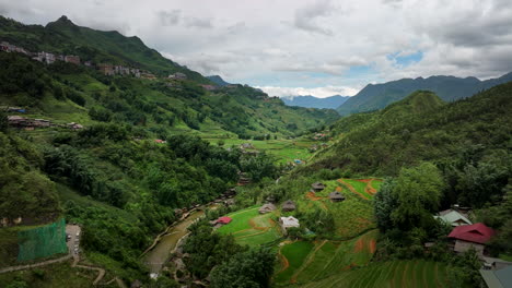 incredibly scenic cat cat village in lush valley surrounded by mountains, aerial