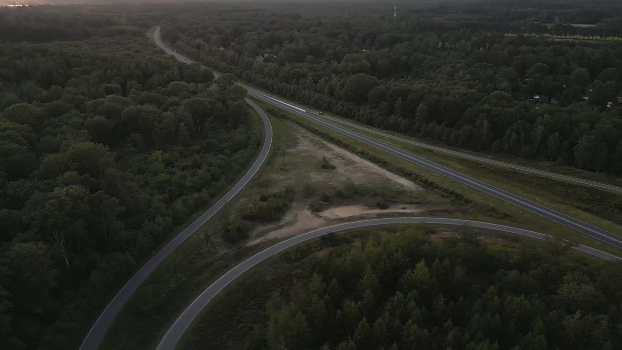Aerial View of Highway Intersection Through Forest