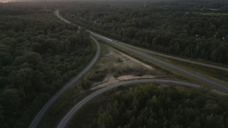 aerial view of highway intersection through forest