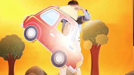 little boy with a red car in the studio. yellow background. bright scenery.