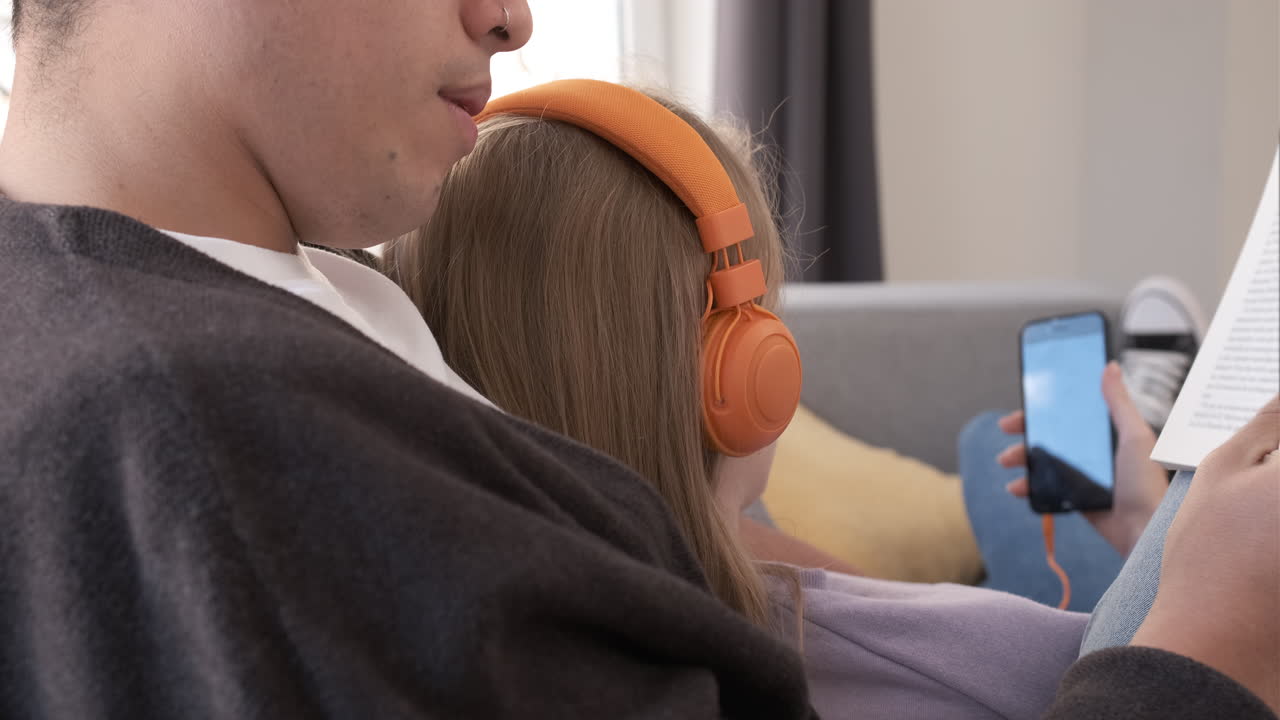Close up of a couple relaxing and spending time together on the couch while staying at home