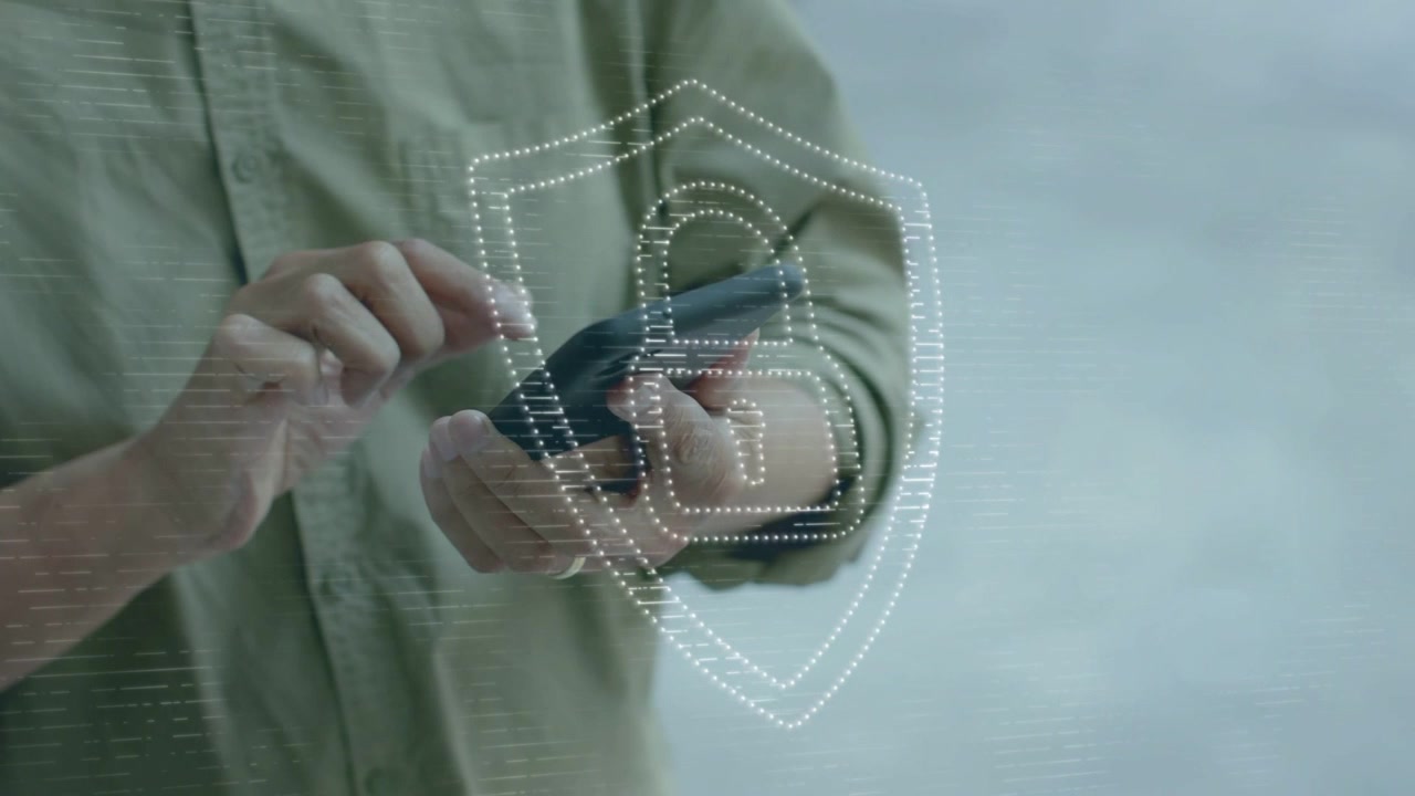 Mature man tapping phone starting animated security shield and lock growing, protecting data