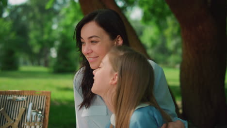 Mother-laughing-with-daughter-on-picnic-closeup.-Happy-family-rest-concept