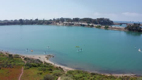 aerial shot flying over kayakers on the carlsbad lagoon recreational area, america