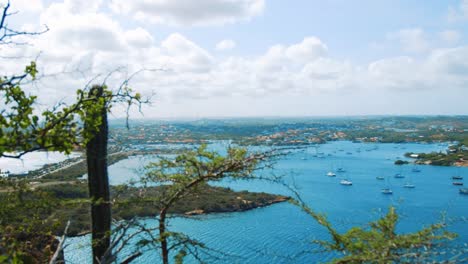 Boats-mooring-in-a-colorful-Caribbean-harbor,-seen-from-above,-Pan