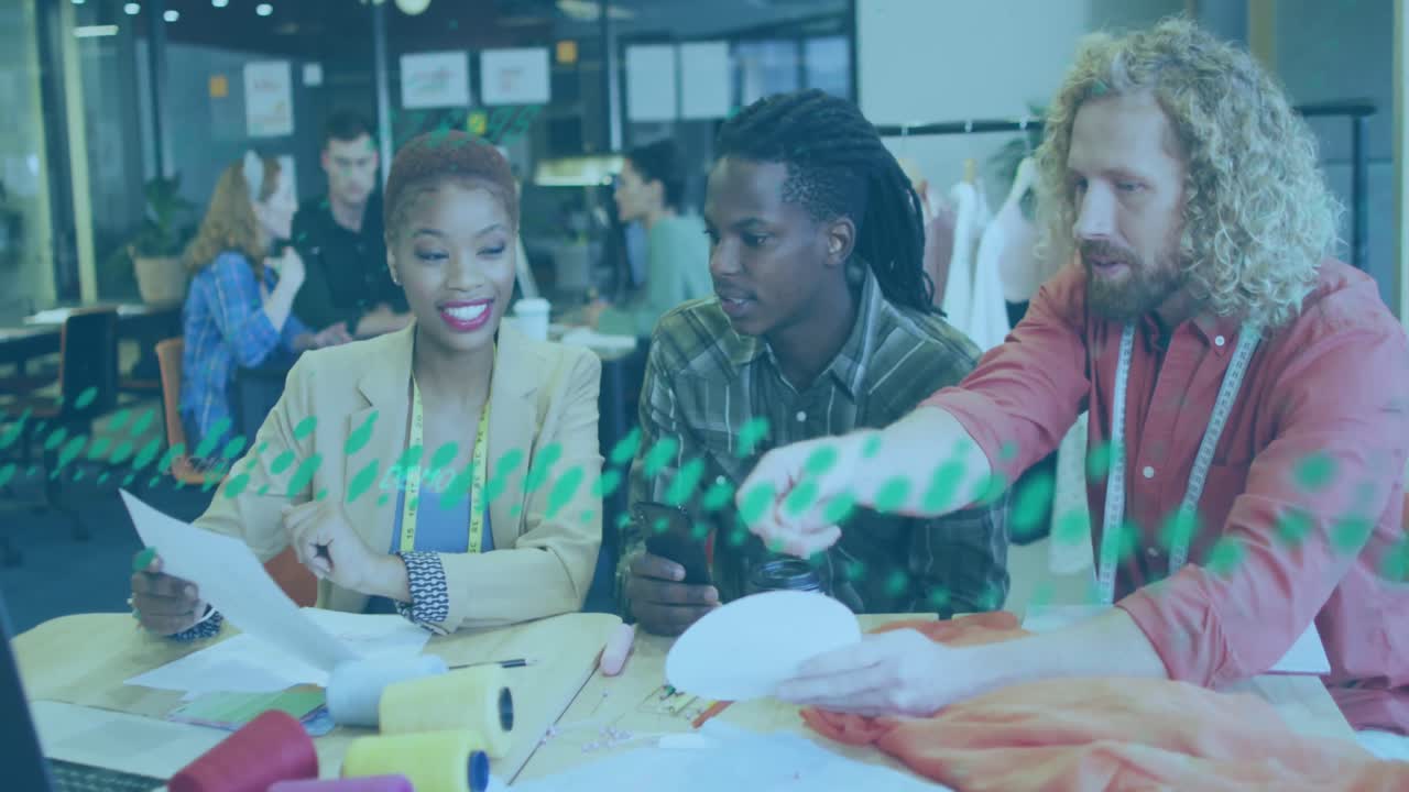 Animation of graphs moving over diverse designers choosing from colour swatch at desk