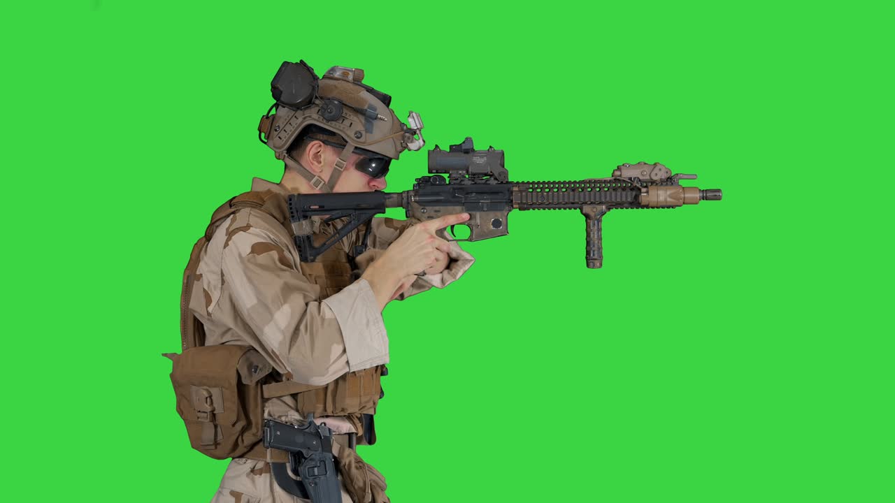 Soldier changing clip with bullets on automatic rifle while walking on ...