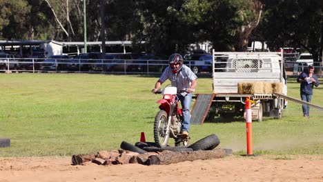 rider navigates obstacles on dirt track