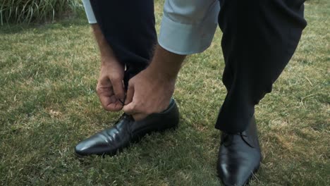 groom binds his shoes and socks