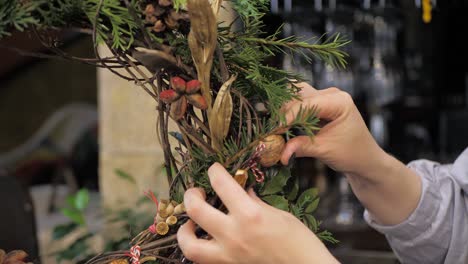 florist at work. how to make christmas wreath with floral arrangement. step by step, tutorial