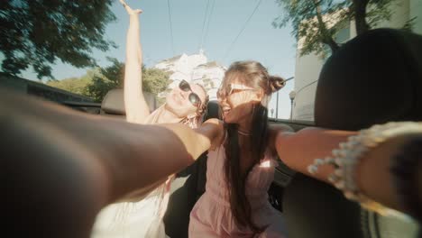 women enjoying a convertible ride