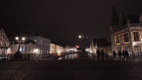 static wide shot of st michaels bridge with walking people during night