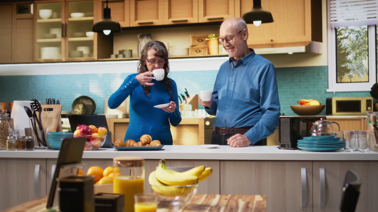Portrait of senior joyous couple enjoying retired life in the kitchen