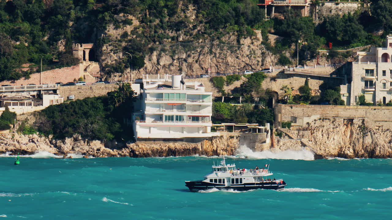 Nice, France - March 17, 2025: View of a boat moving on the blue sea near the coast in daylight