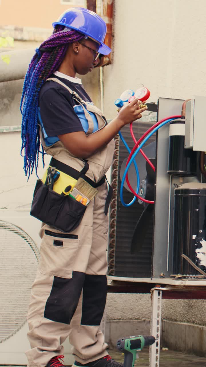 Vertical video Mechanic looking at refrigerant levels