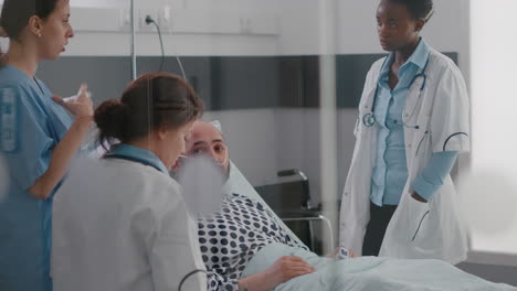 doctors team monitoring man explaining disease symptom