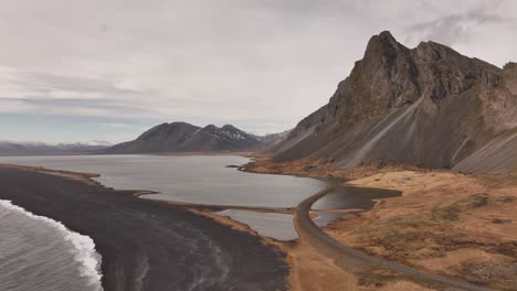 drone view of vestrahorn and stokksnes beach with dramatic peaks and black sand coastline in iceland.