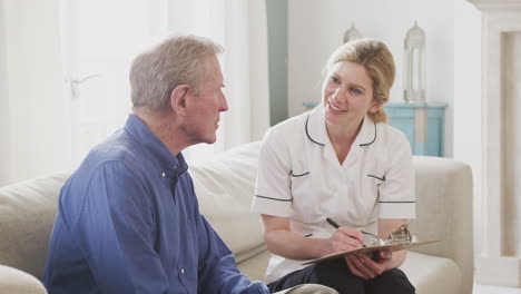 female doctor making home visit to senior man for medical check