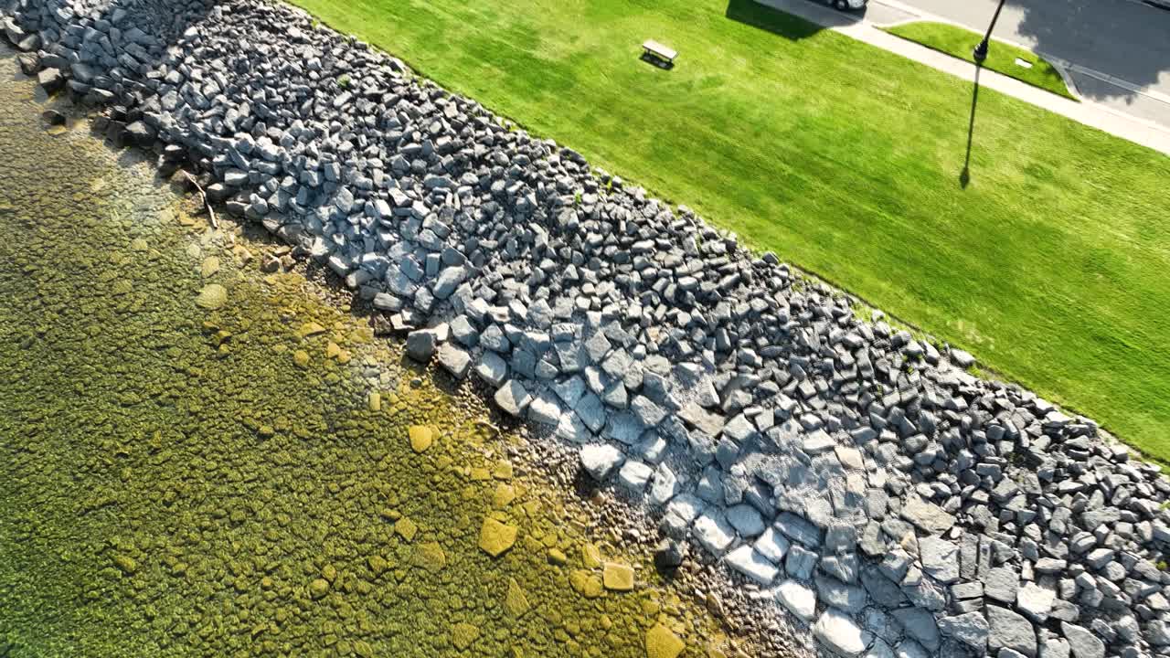 Rising motion with spin away from subject on a rocky beach