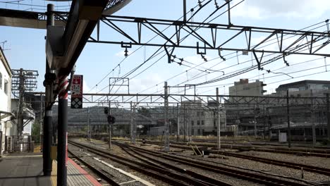 multiple tracks and overhead wires extending from kyoto station