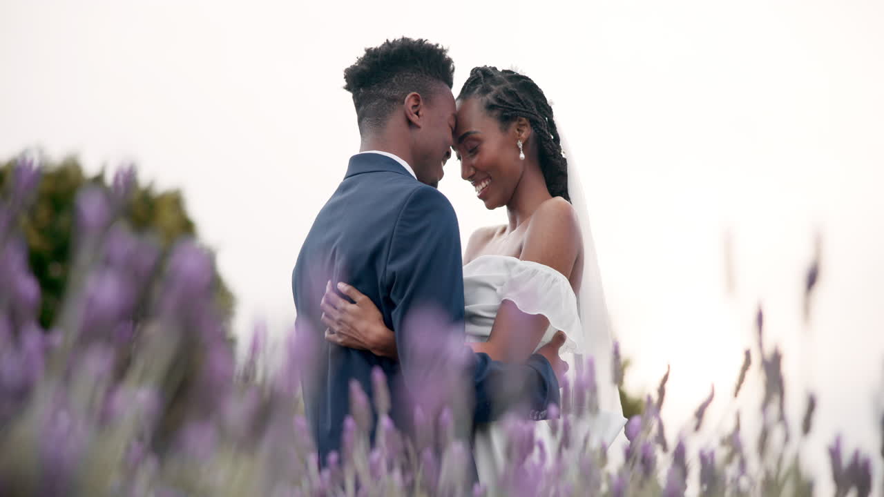Wedding, bride and groom hug in a field