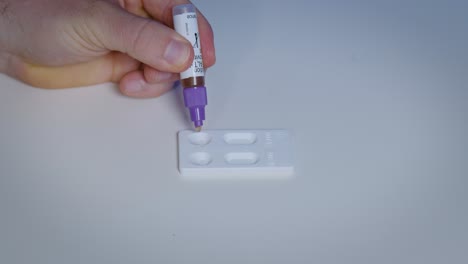 Dropping-mix-of-urine-and-solution-at-immunological-rapid-test-for-self-testing