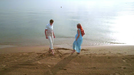 romantic couple drawing heart on sand. steady shot of love couple