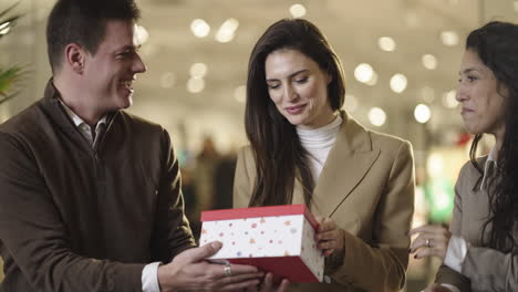 woman's joyful reaction to a surprise gift from friends