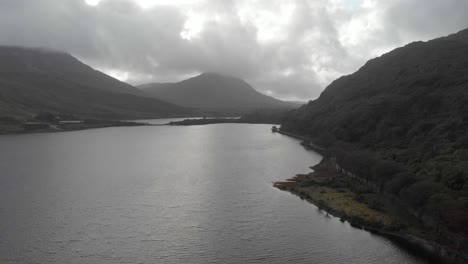 Aerial:-Moody-landscape-of-amazing-mountains-next-to-lake-in-Ireland