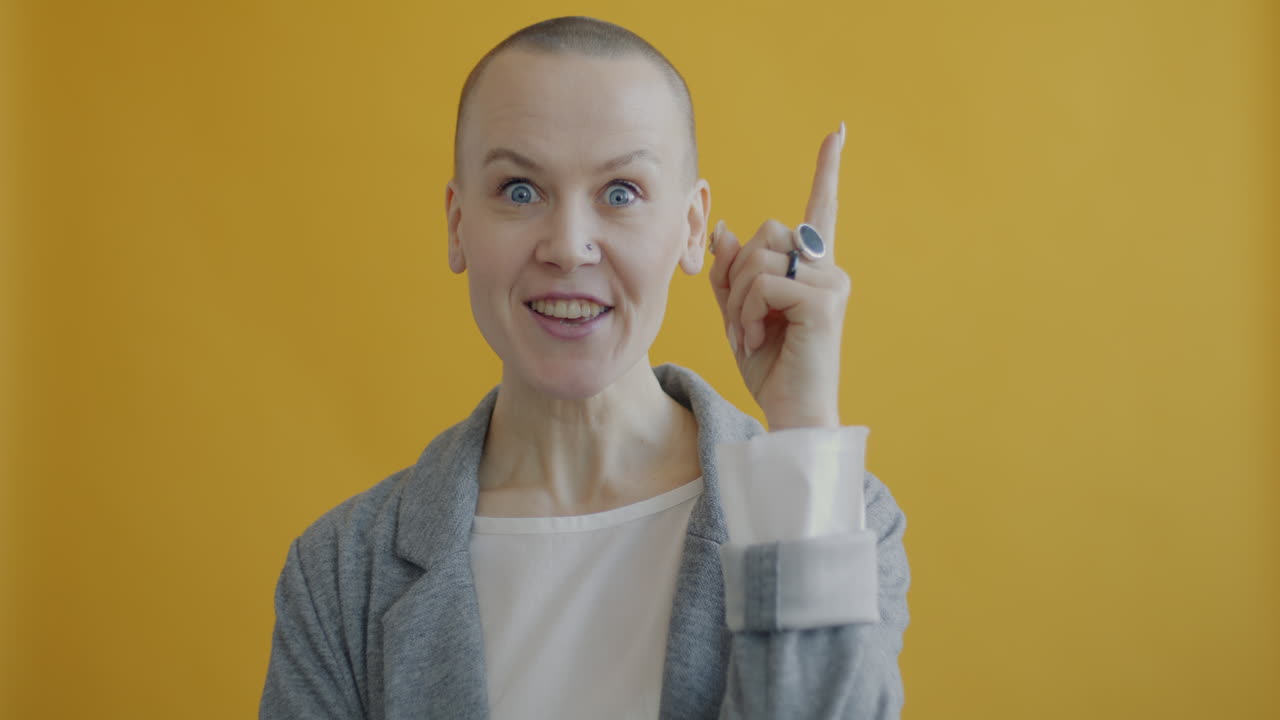 Donna con capelli corti in posa davanti a uno sfondo giallo