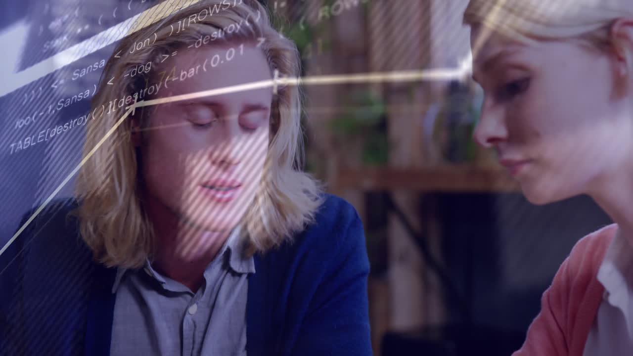 Two software developers collaborating in modern office, with animated code overlay guiding workflow