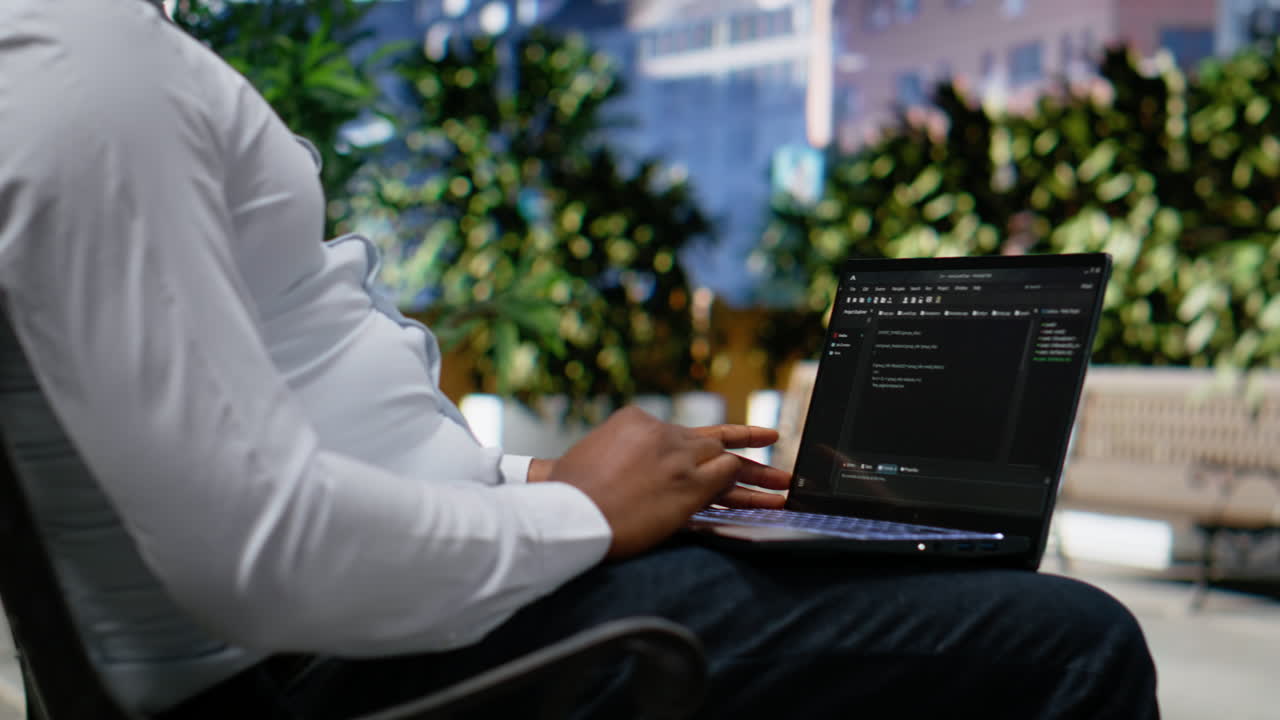 Confident adult reviews binary code script for his programming remote work