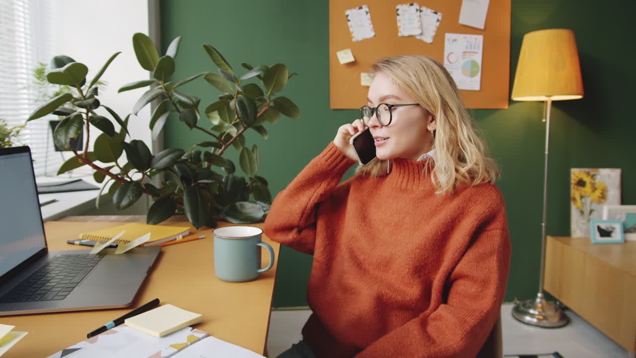 Woman working from home, happy on phone call