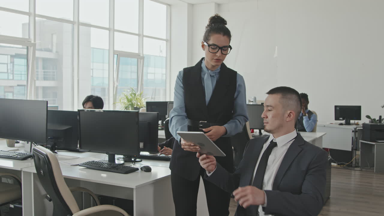 Businesswoman and Businessman in Workplace