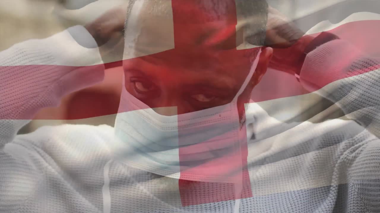 animación de la bandera de inglaterra ondeando sobre un hombre que usa una máscara facial durante la pandemia de covid-19