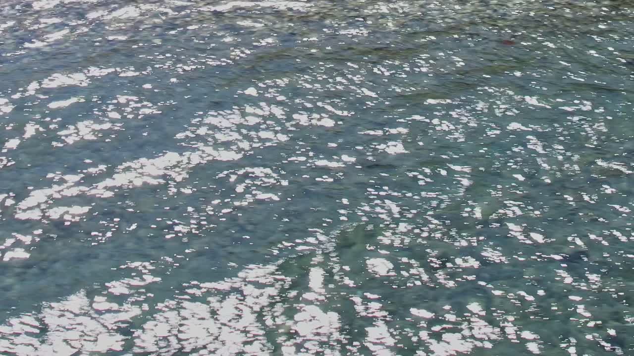 Kirkas sininen vesi kimaltelee Rodoksella, Kreikassa, kirkkaassa auringonvalossa