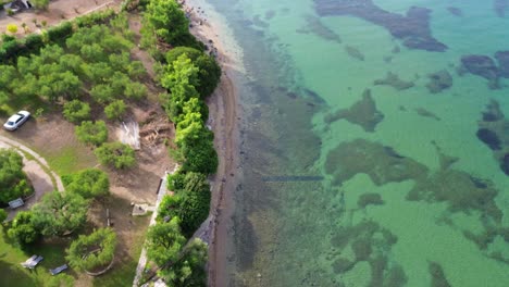 Aerial-footage-of-the-sun-kissed-Gerakini-Beach-in-Yerakini,-Halkidiki,-Greece,-recorded-with-a-high-quality-4K-drone