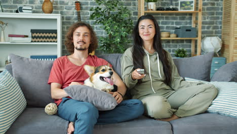 couple relaxing at home with dog