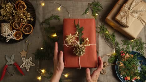 woman puts christmas present on table